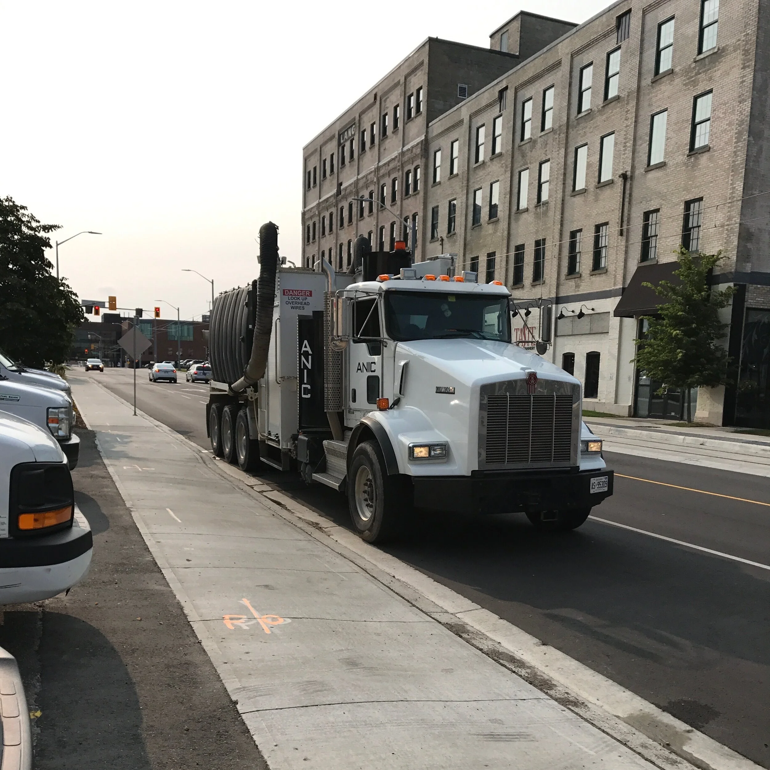 ANIC Kenworth hydro vac truck on a downtown street